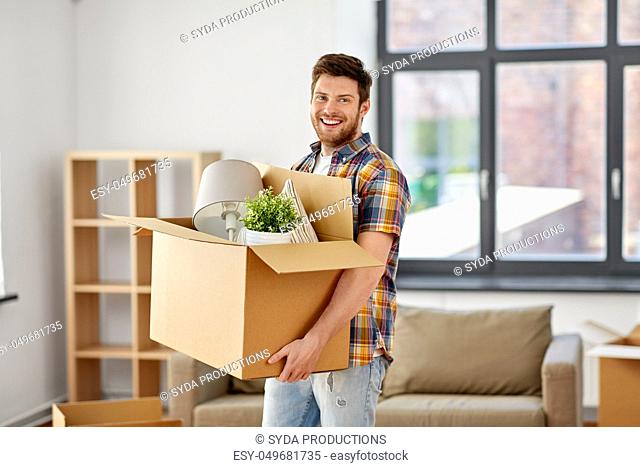 happy man with box moving to new home