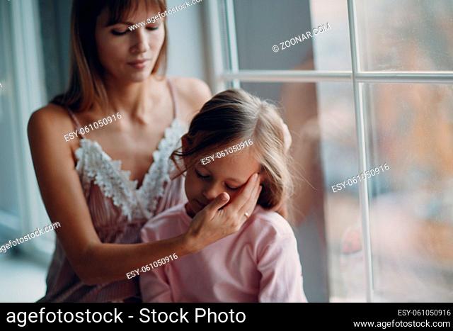 Mother and little daughter child girl at home. Single parenting and motherhood