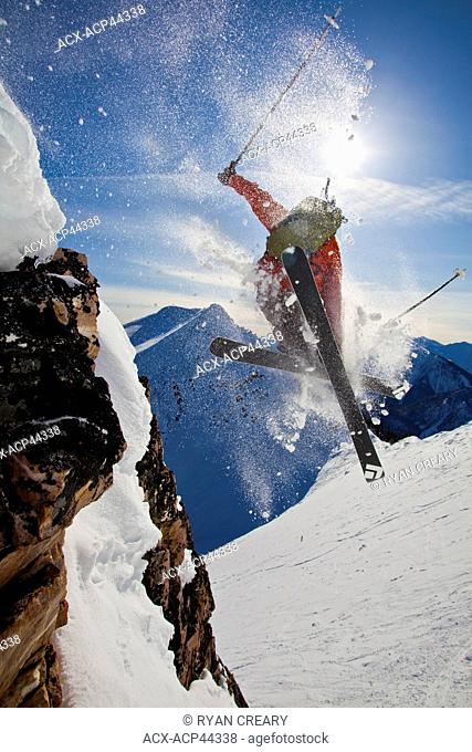 A young male skier airs a cliff in the kicking horse backcountry, Golden, Britsh Columbia, Canada