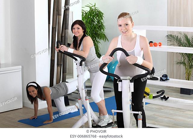 Young women using gym equipment
