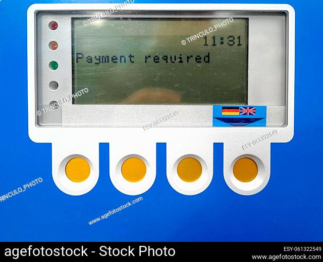 LCD control panel and function keys of a blue parking meter with the prompt Payment required