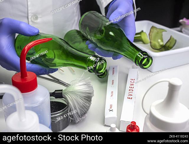 Police expert gets blood sample from glass bottle in Criminalistic Lab