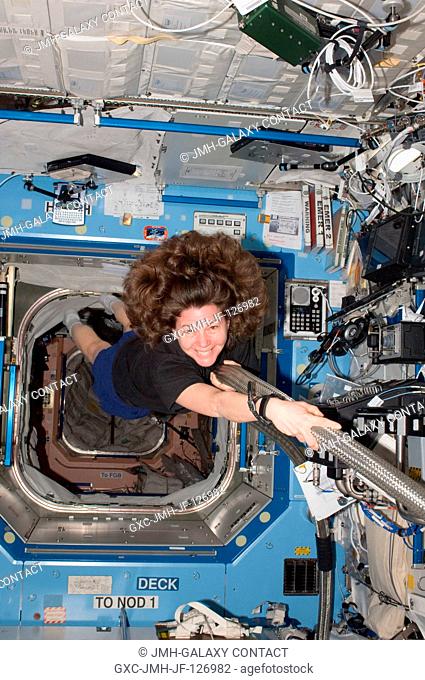 NASA astronaut Cady Coleman, Expedition 27 flight engineer, works with the Major Constituent Analyzer Data Control Assembly (MCA DCA) in the Destiny laboratory...