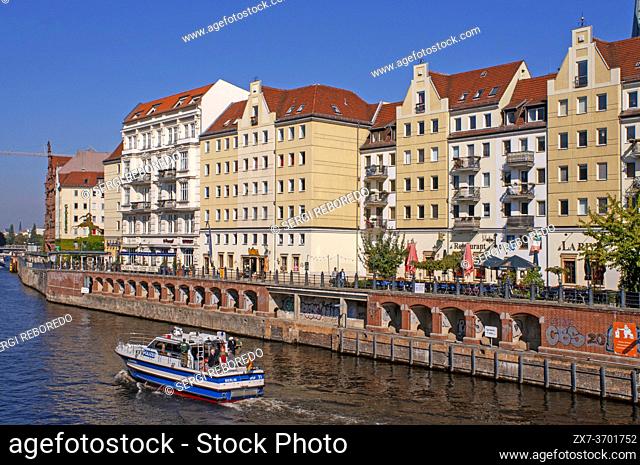 Police boat in The River Spree, running alongside the Nikolaiviertel, leads towards the historical landmark of Berlin Cathedral Germany