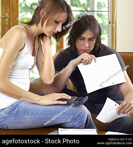 Male and female student reconciling accounts