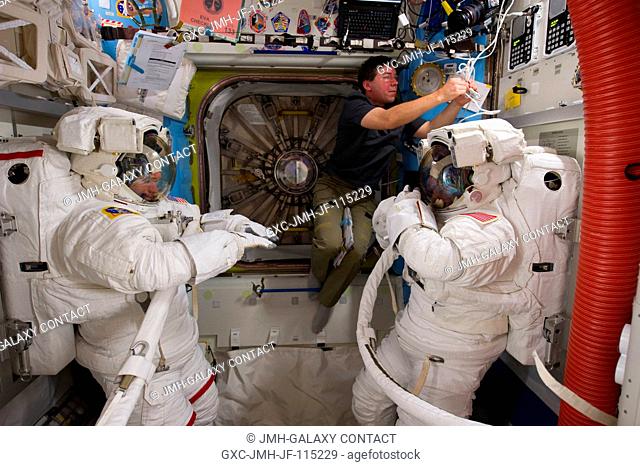 NASA astronauts Steve Bowen (left), Michael Barratt (center) and Alvin Drew, all STS-133 mission specialists, are pictured in the Quest airlock of the...