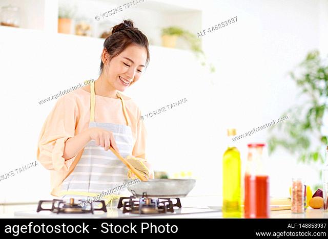 Young Japanese woman in the kitchen