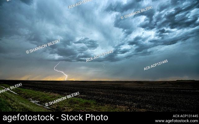 Storm with lightning striking over field in rural southern Manitoba Canada