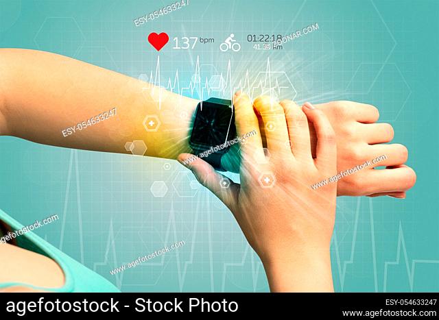 Hand with smartwatch and cycling concept nearby