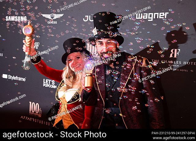 09 December 2023, Bavaria, Munich: Tamer and Blondi stand on the red carpet in front of ""The Charles"" hotel with lots of bubbles at the celebration for the...