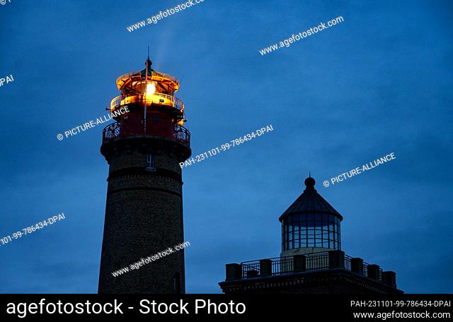 01 November 2023, Mecklenburg-Western Pomerania, Putgarten auf Rügen: The Cape Arkona lighthouse on the island of Rügen sends its light out into the Baltic Sea