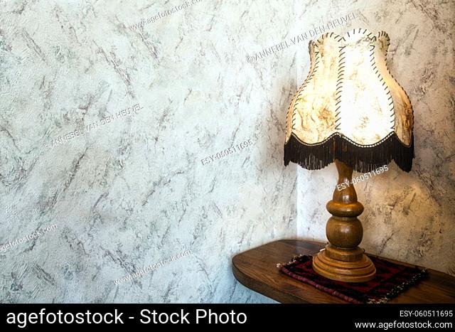 Old fashion table lamp near vintage stylish wallpaper with copy space, antique design space for text