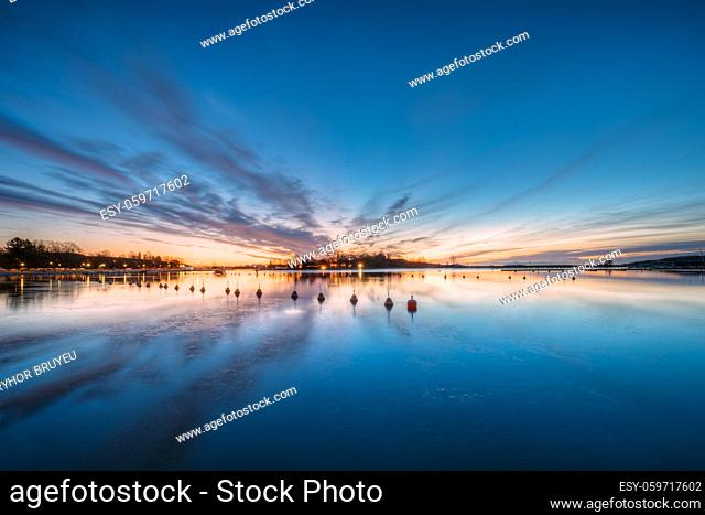 Helsinki, Finland. Landscape With City Pier, Jetty At Winter Sunrise Or Sunset Time. Tranquil Sea Water Surface At Early Morning Near Havsparken Meripuisto