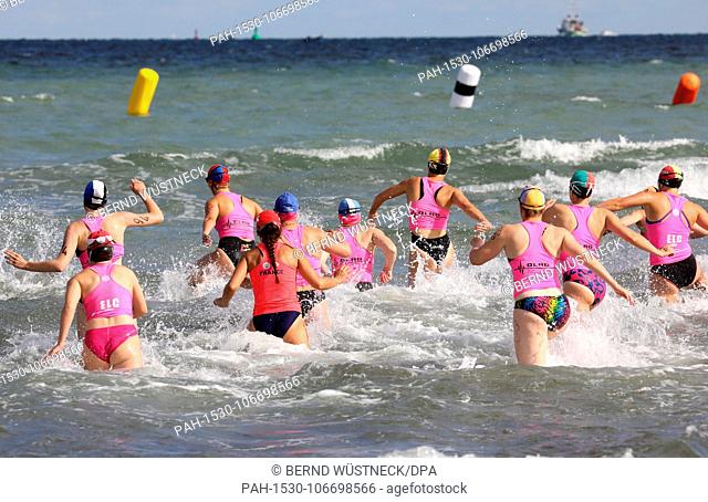 20 July 2018, Germany, Warnemuende: An oceanwoman race taking place at the Baltic Sea coast during the 22nd International DLRG Cup in rescue swimming