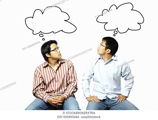 An isolated shot of two businessmen reading each other's thoughts