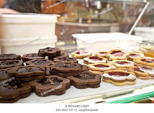close-up of cakes and biscuits behind display amalfi italy