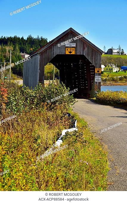 A vertical image of the one lane covered bridge at Tynmouth New Brunswick Canada taken on a clear autumn day