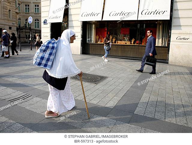 Beggar in front of the Cartier boutique on Avenue des Champs Elysées in Paris, France, Europe