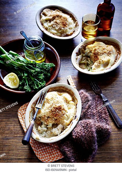 Still life of snapper and cauliflower pie bake with broccolini