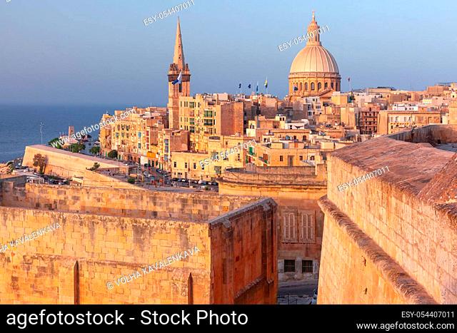 View of Old town roofs, fortress, Our Lady of Mount Carmel church and St. Paul's Anglican Pro-Cathedr al sunset , Valletta, Capital city of Malta