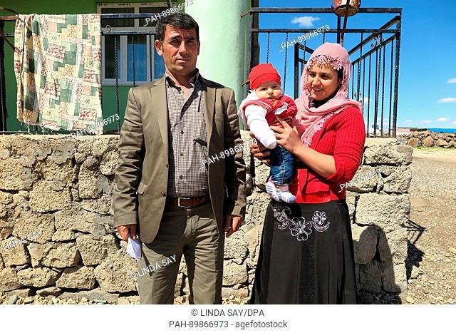 The Celik family in front of their house in Ergani, in the Turkish province of Diyarbakir, Turkey, 10 April 2017. Mother Songül Celik is holding her daughter in...