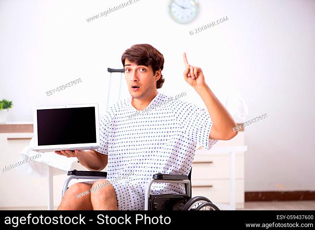 Young handsome man in wheelchair at the hospital