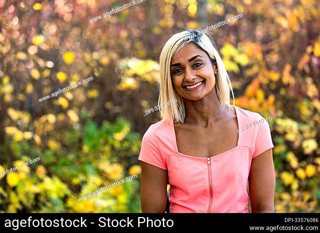 Head and shoulders portrait of a woman outdoors in autumn; Edmonton, Alberta, Canada