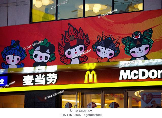 Olympics official Fuwa mascot characters on McDonalds fastfood restaurant, Wangfujing Street, Beijing, China