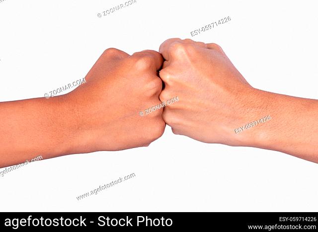 Female hands making signs with their fists closed touching each other