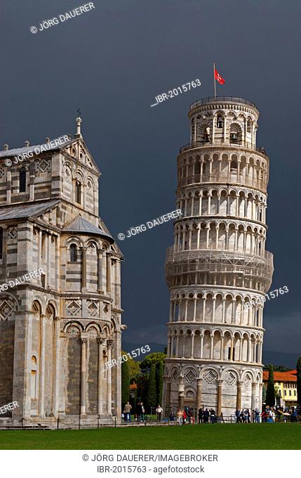 The Leaning Tower of Pisa against dark clouds, Tuscany, Italy, Europe