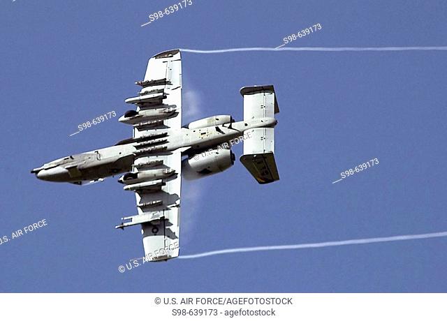 ROYAL AIR FORCE MIDENHALL, England - An A-10 Thunderbolt II rolls to mark a target with simulated M-156 white phosphorus rockets as part of an aerial...
