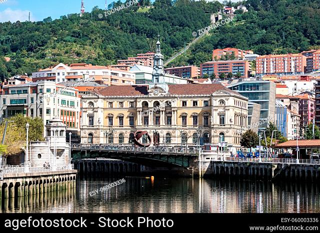 The cityscape of Bilbao, Spain. The Nervion river crosses Bilbao downtown, hosting in its margins the traditional and modern buildings of the city