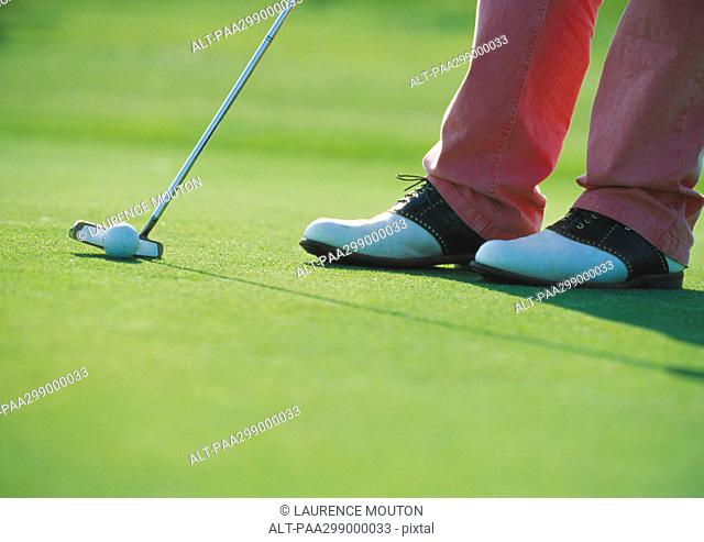 Golfer putting, close-up
