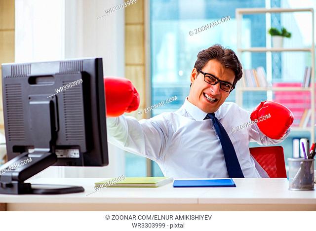 Businessman with boxing gloves in the office
