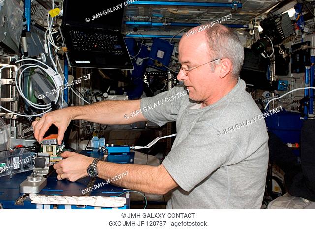 NASA astronaut Jeffrey Williams, Expedition 22 commander, services the Tropism in Plants (TROPI2) experiment in the Columbus laboratory of the International...