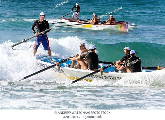 Surfboat teams racing at Cronulla Beach, as part of a surf lifesaving carnival  Sydney, New South Wales, Australia