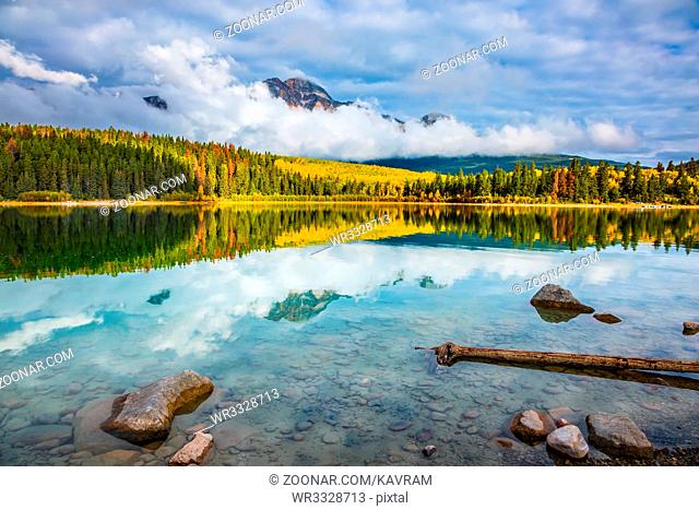 Autumn in the Rocky Mountains. Patricia Lake amongst the forests, yellow bushes and mountains