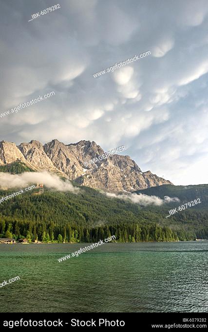 Eibsee lake in front of Zugspitze massif with Zugspitze, dramatic Mammaten clouds, Wetterstein range, near Grainau, Upper Bavaria, Bavaria, Germany, Europe