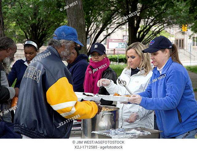 Detroit, Michigan - Volunteers feed homeless people from tables set up in Cass Park  The informal group brings food to the park once every two weeks