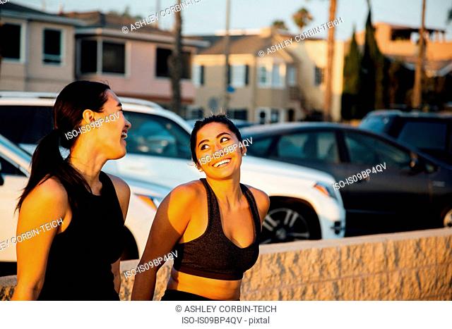 Friends talking by beach, Long Beach, California, US