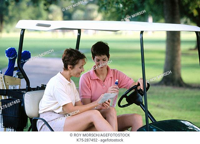 gwo women checking their scorecard on golf course