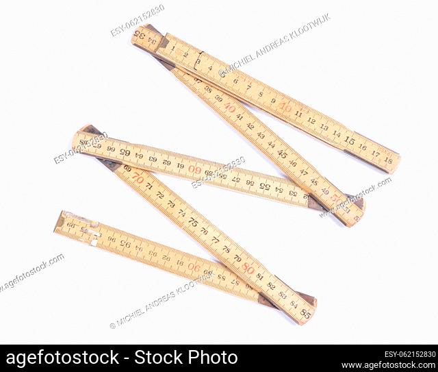 Old folding wooden ruler, isolated on white