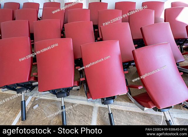 PRODUCTION - 23 August 2023, Bavaria, Munich: Dozens of chairs from the largely dismantled plenary hall of the Bavarian state parliament lie lined up in the...