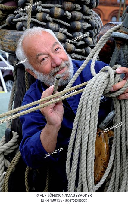 Sailor with rope and tackle on an old sailing ship