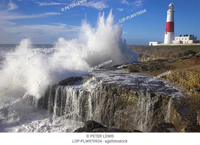 England, Dorset, Portland Bill, Stormy waves crashing onto the rocks by Portland Bill Lighthouse in Dorset