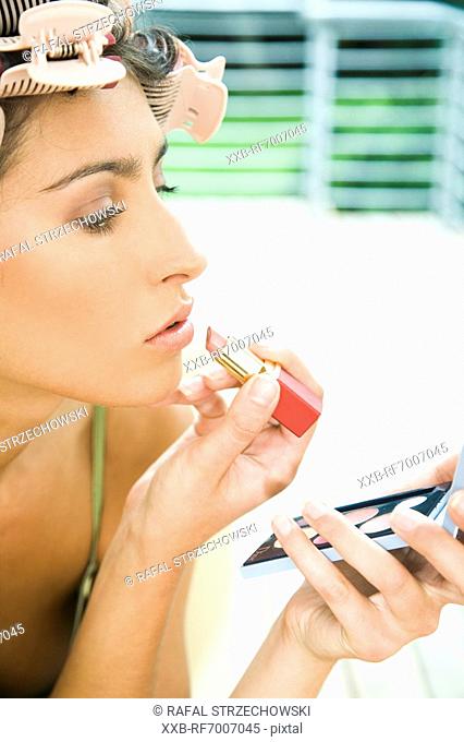 Young woman doing make up