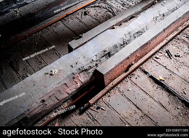 weak wooden floor beam in old attic / loft with support construction -