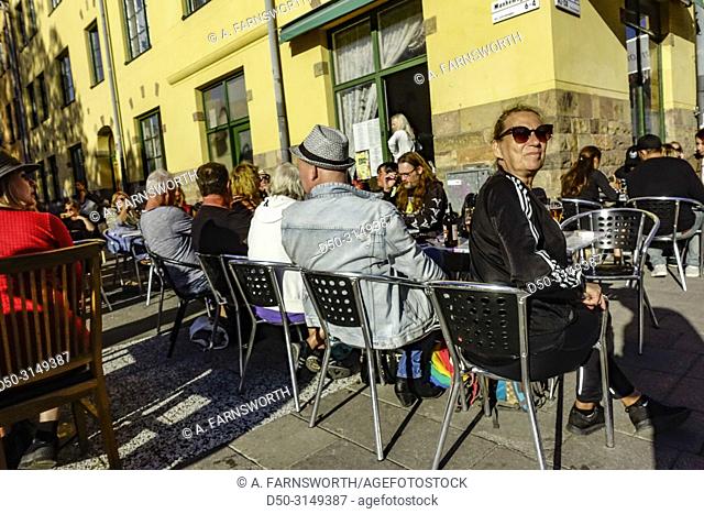 Stockholm, Sweden restaurant guests sit outside during the annual Aspudden flea market