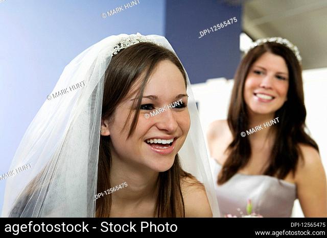 Cheerful bride with bridesmaid