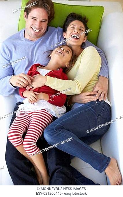 Overhead View Of Family Relaxing On Sofa